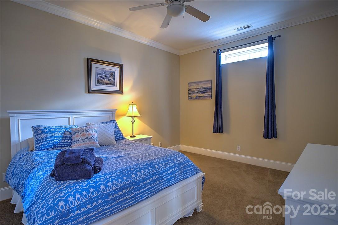 9543 Island Point Road Sherrills Ford, NC 28673 - Photo 19 of 31 a bed sitting in a bedroom next to a window