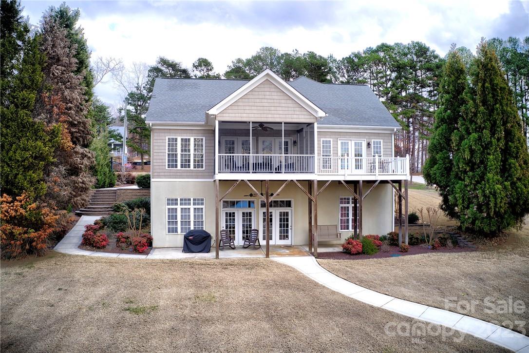 9543 Island Point Road Sherrills Ford, NC 28673 - Photo 26 of 31 a front view of a house with a garden and a tree