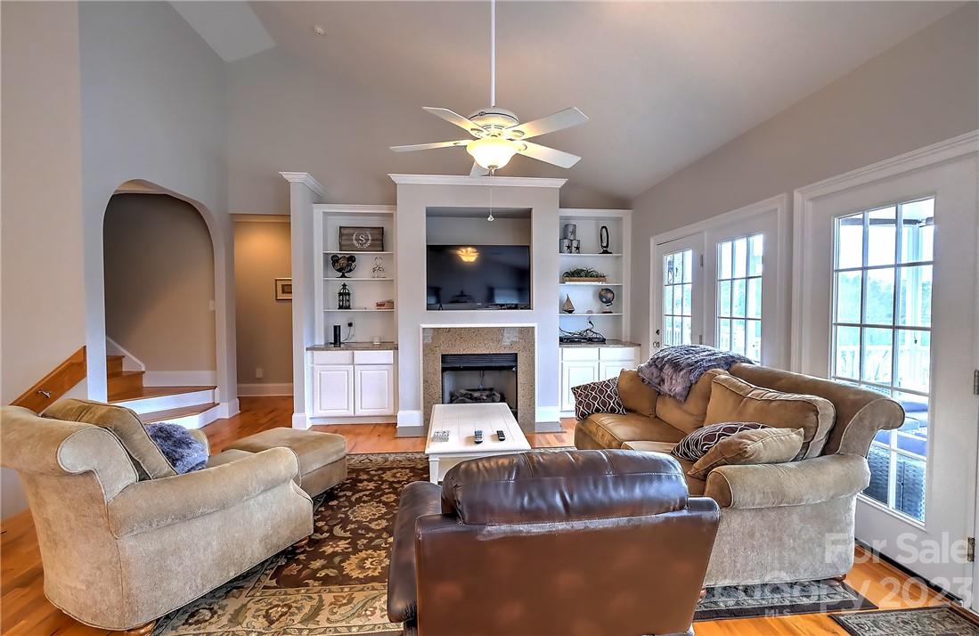9543 Island Point Road Sherrills Ford, NC 28673 - Photo 4 of 31 a living room with furniture a fireplace and a chandelier