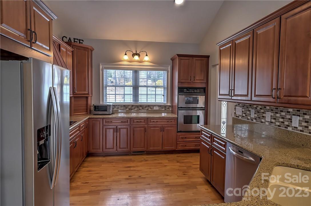 9543 Island Point Road Sherrills Ford, NC 28673 - Photo 7 of 31 a kitchen with stainless steel appliances granite countertop a refrigerator stove and sink