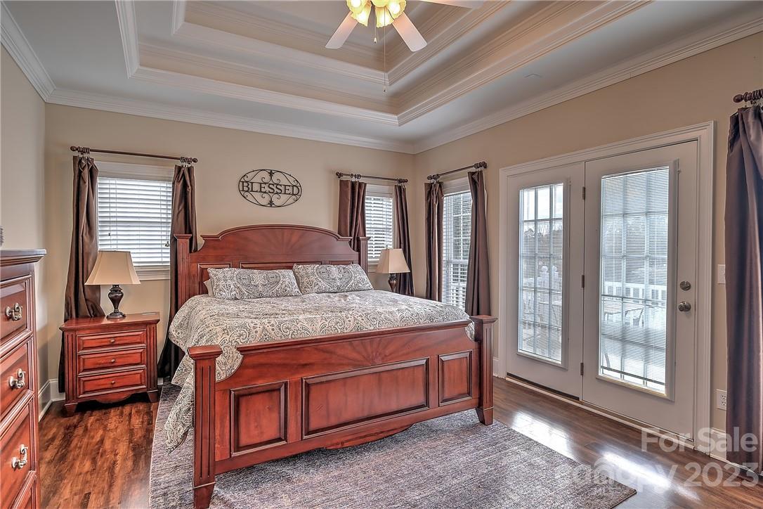 9543 Island Point Road Sherrills Ford, NC 28673 - Photo 9 of 31 a bedroom with a bed and a chandelier next to a window
