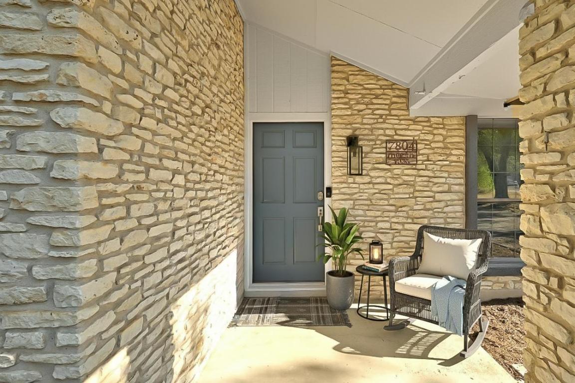 7804 Phoenix Pass Austin, TX 78737 - Photo 2 of 34 Doorway to property with covered porch and stone siding