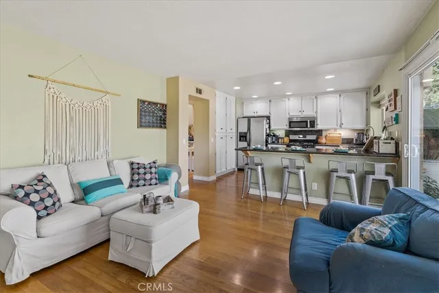 a living room with furniture and kitchen view