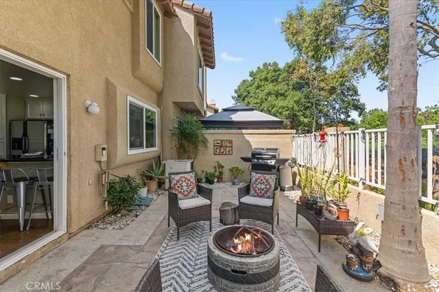 a view of a patio with table and chairs potted plants