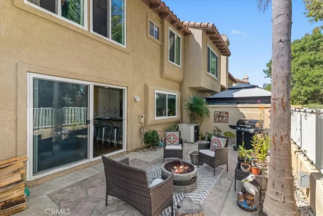 a view of a patio with couches table and chairs and potted plants