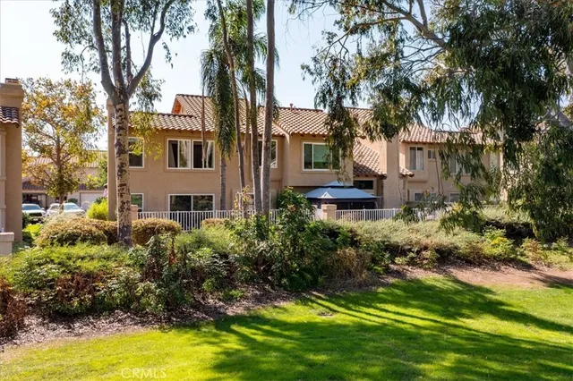 a view of a house with a yard and sitting area