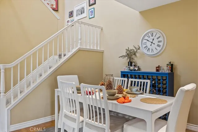 a view of a dining room with furniture and a chandelier
