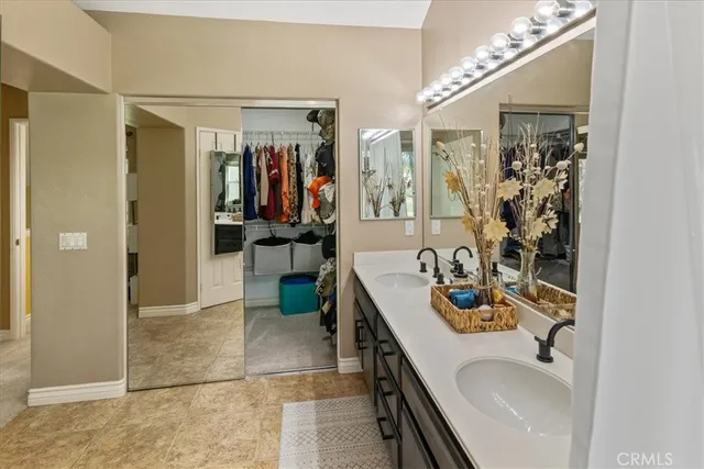 a bathroom with a double vanity sink and a mirror