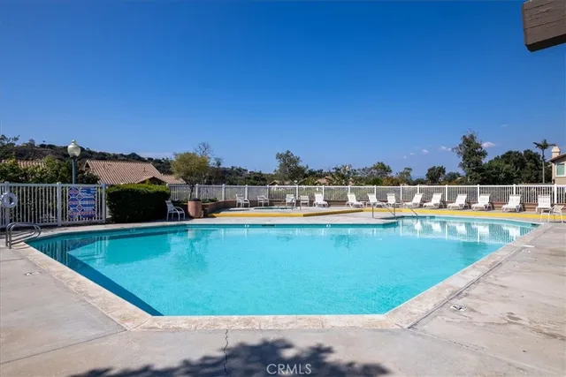 a view of a swimming pool with a lounge chair