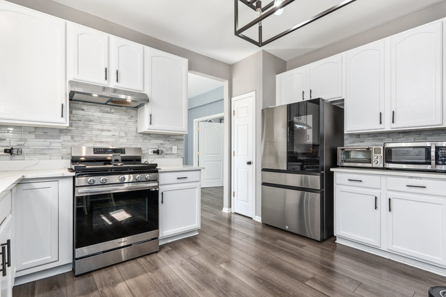 2602 Lundquist Drive Aurora, IL 60503 - Photo 11 of 30 a kitchen with stainless steel appliances a stove a refrigerator and a stove top oven