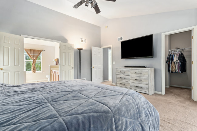 2602 Lundquist Drive Aurora, IL 60503 - Photo 14 of 30 a bedroom with a bed and a flat screen tv
