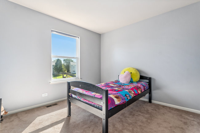 2602 Lundquist Drive Aurora, IL 60503 - Photo 16 of 30 a bedroom with a bed and a window