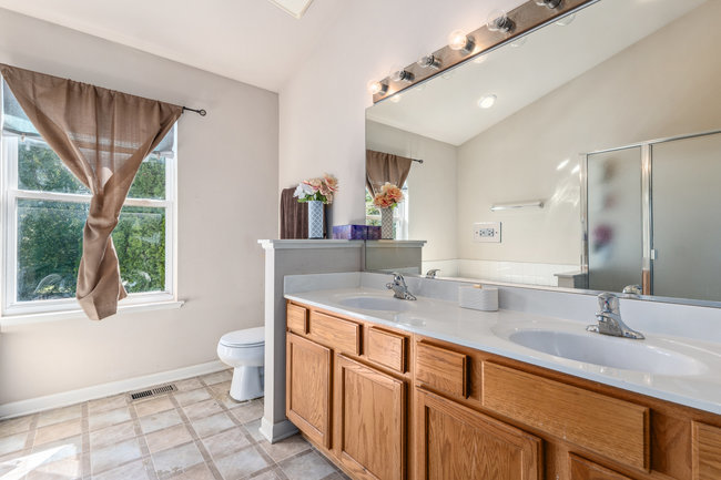 2602 Lundquist Drive Aurora, IL 60503 - Photo 18 of 30 a bathroom with a granite countertop sink mirror vanity and a toilet