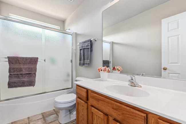 2602 Lundquist Drive Aurora, IL 60503 - Photo 19 of 30 a bathroom with a sink a toilet and shower