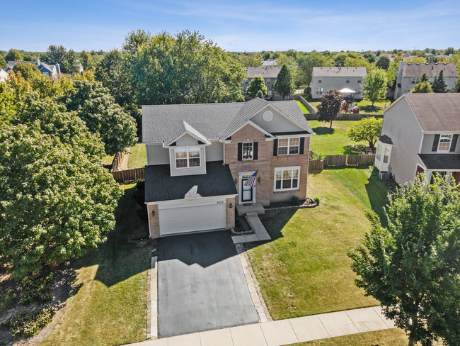2602 Lundquist Drive Aurora, IL 60503 - Photo 2 of 30 aerial view of a house with a big yard and large tree