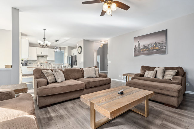 2602 Lundquist Drive Aurora, IL 60503 - Photo 7 of 30 a living room with furniture and a chandelier