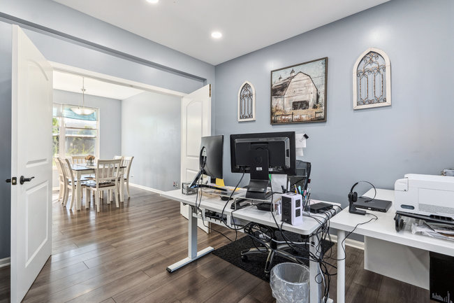 2602 Lundquist Drive Aurora, IL 60503 - Photo 9 of 30 a view of a workspace with furniture and a flat screen tv