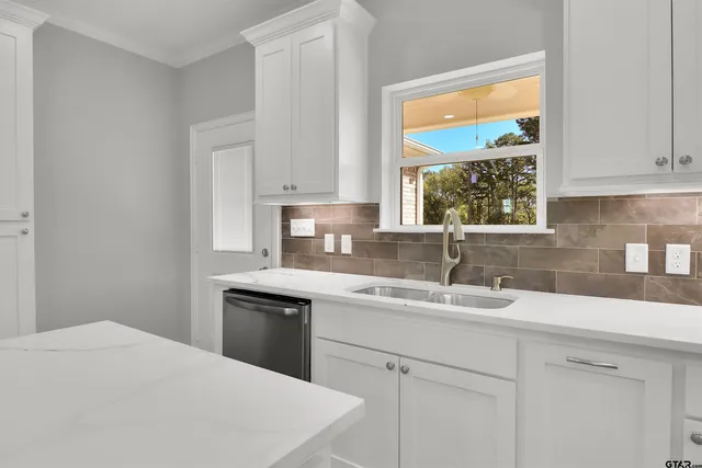 a kitchen with a sink stove and cabinets