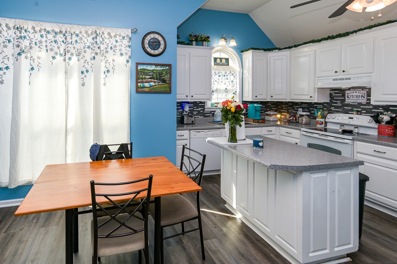 280 Flintville School Road Elora, TN 37328 - Photo 11 of 40 a kitchen with stainless steel appliances a dining table chairs and a refrigerator