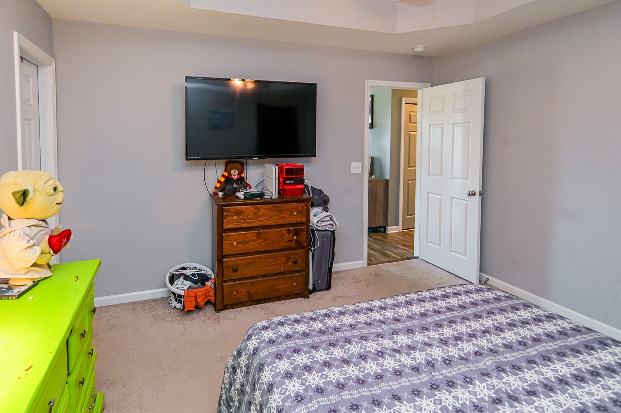 280 Flintville School Road Elora, TN 37328 - Photo 20 of 40 a bedroom with a bed and flat screen tv