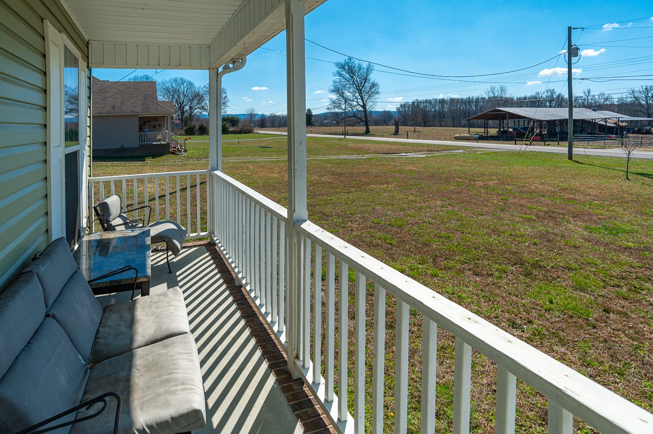 280 Flintville School Road Elora, TN 37328 - Photo 4 of 40 a view of balcony with two large trees and wooden fence