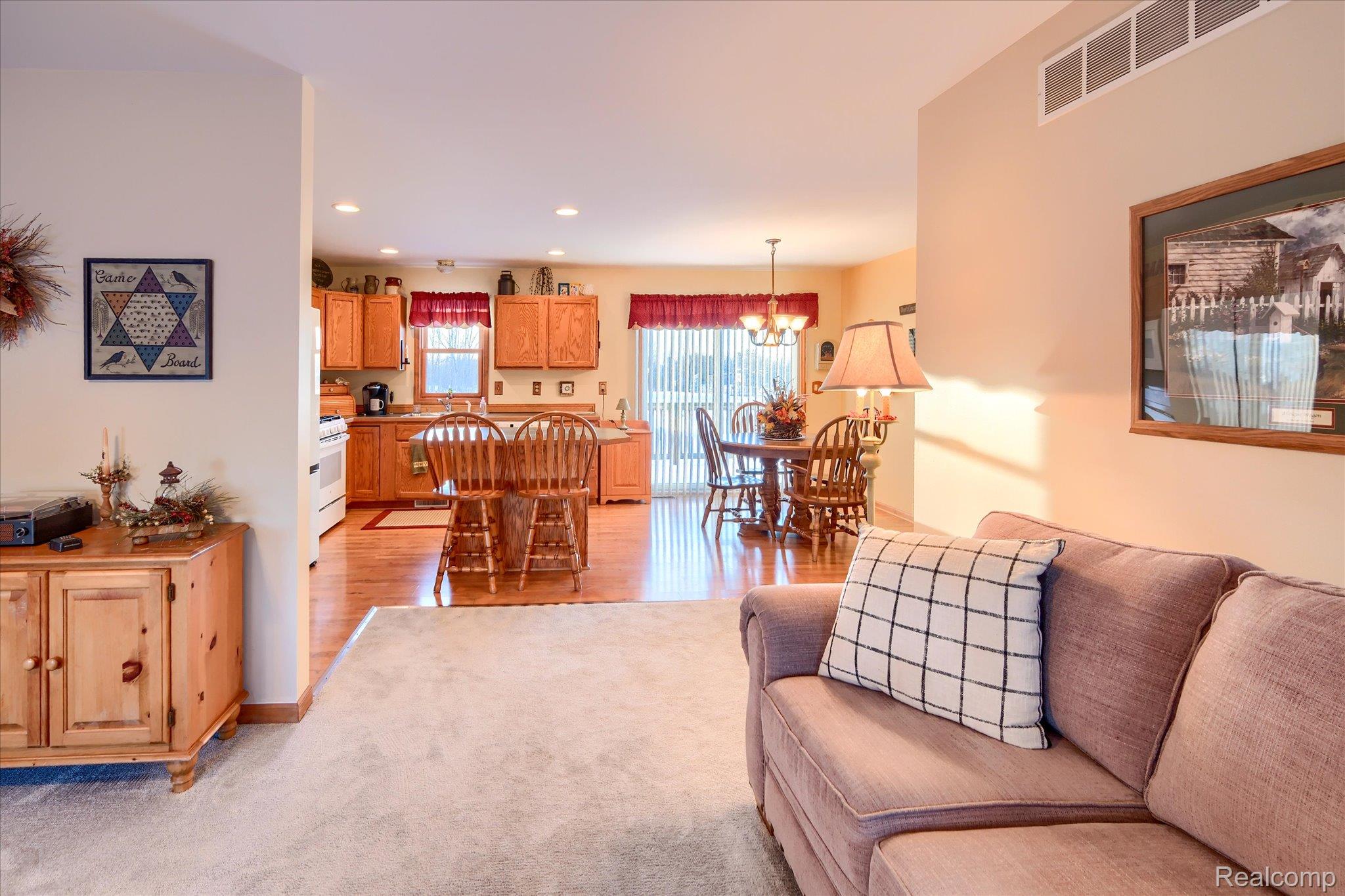 6941 North Lake Pleasant Road North Branch, MI 48461 - Photo 9 of 51 Living room featuring recessed lighting, light colored carpet, and a chandelier