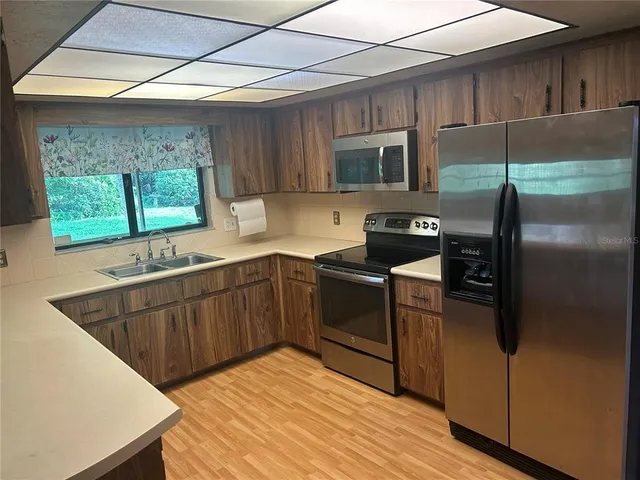 a kitchen with a refrigerator and a sink