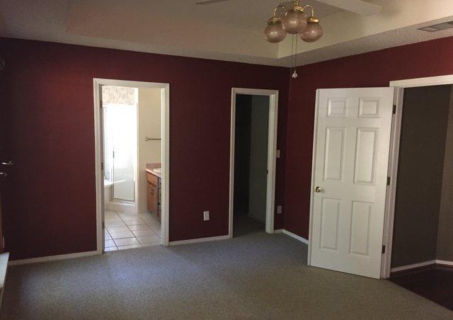 4587 Top Flight Drive Crestview, FL 32539 - Photo 6 of 16 an empty room with chandelier fan and hallway