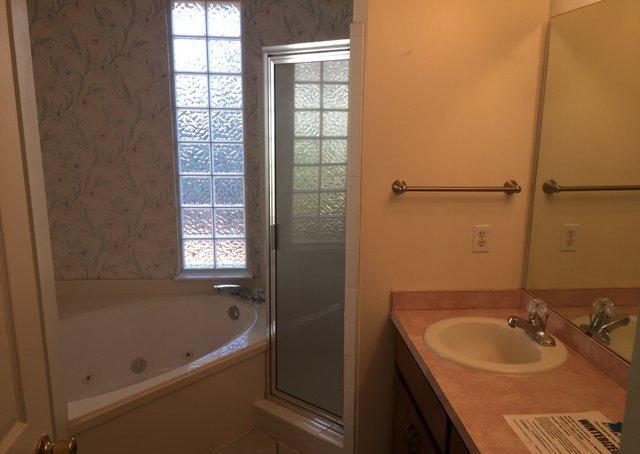 4587 Top Flight Drive Crestview, FL 32539 - Photo 7 of 16 a bathroom with a sink and a bathtub