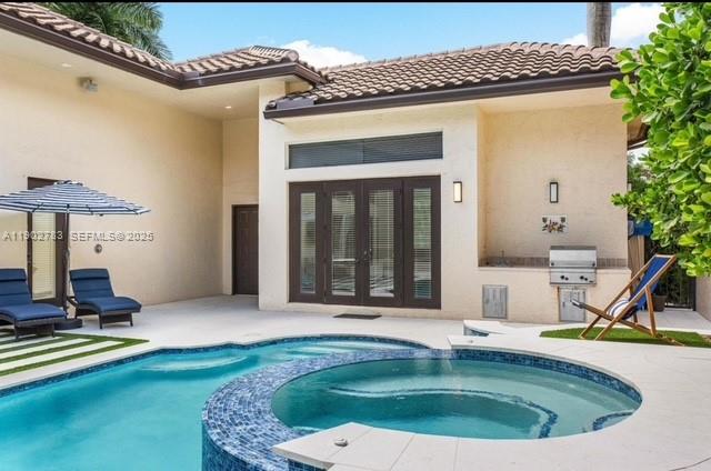 2393 Northwest 49th Lane Boca Raton, FL 33431 - Photo 6 of 21 a swimming pool with barbeque oven in front of it