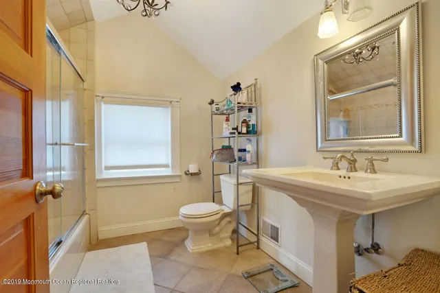 a bathroom with a sink toilet and mirror