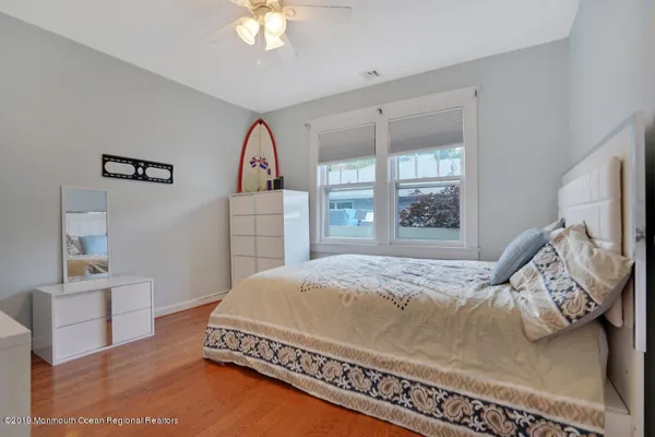 a bedroom with a bed and a dresser