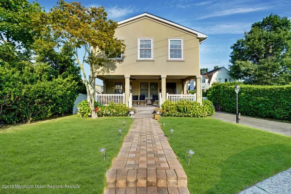 a front view of house with yard and green space