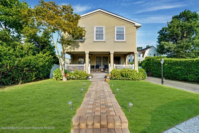 a front view of house with yard and green space