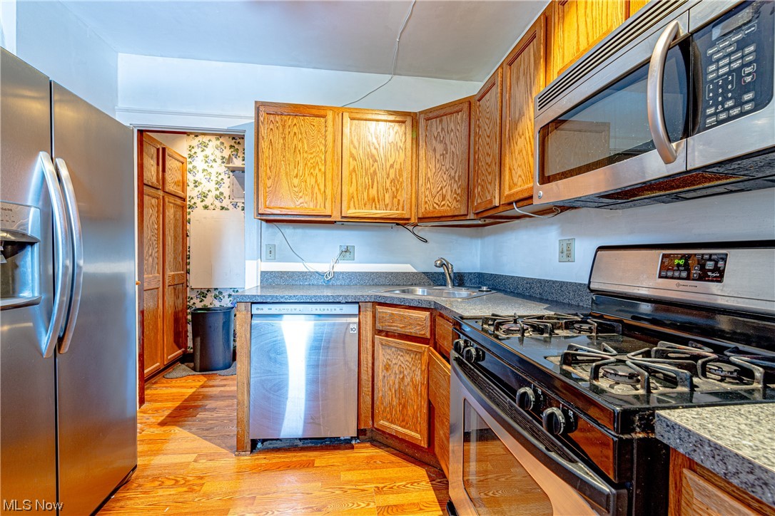 3337 Ralph Avenue Cleveland, OH 44109 - Photo 14 of 30 Kitchen with sink, appliances with stainless steel finishes, and light hardwood / wood-style floors