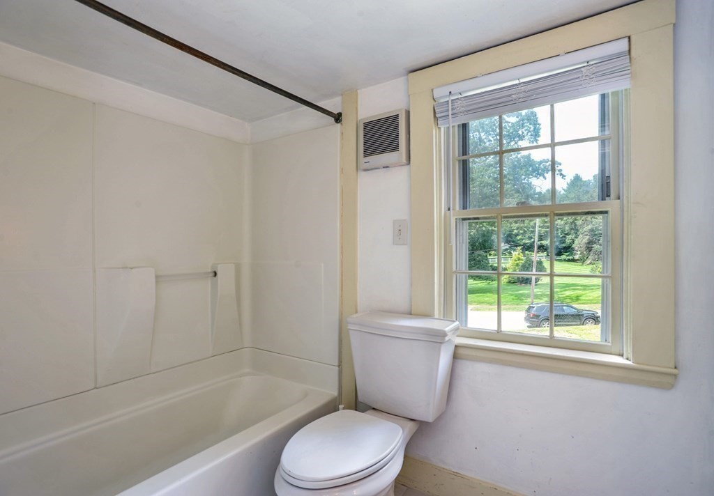 208 Prospect Street Hingham, MA 02043 - Photo 16 of 34 a white toilet and tub next to a window