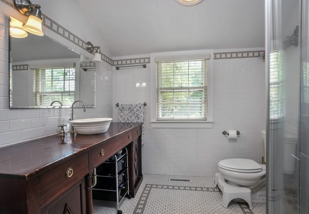 208 Prospect Street Hingham, MA 02043 - Photo 26 of 34 a bathroom with a sink a toilet a mirror and a window