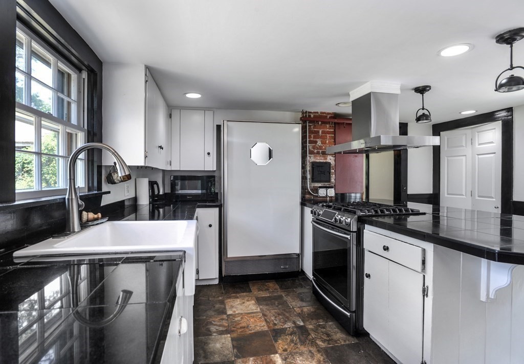 208 Prospect Street Hingham, MA 02043 - Photo 31 of 34 a kitchen with stainless steel appliances granite countertop a refrigerator a stove a sink dishwasher and white cabinets with wooden floor
