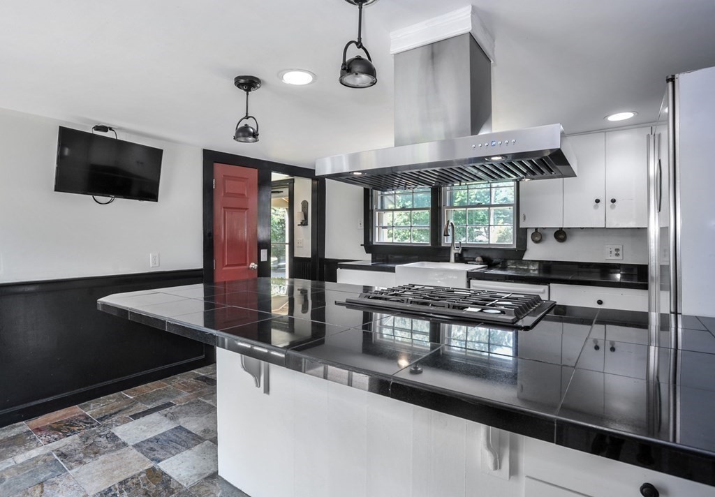 208 Prospect Street Hingham, MA 02043 - Photo 32 of 34 a kitchen with stainless steel appliances granite countertop a sink a stove counter space and cabinets