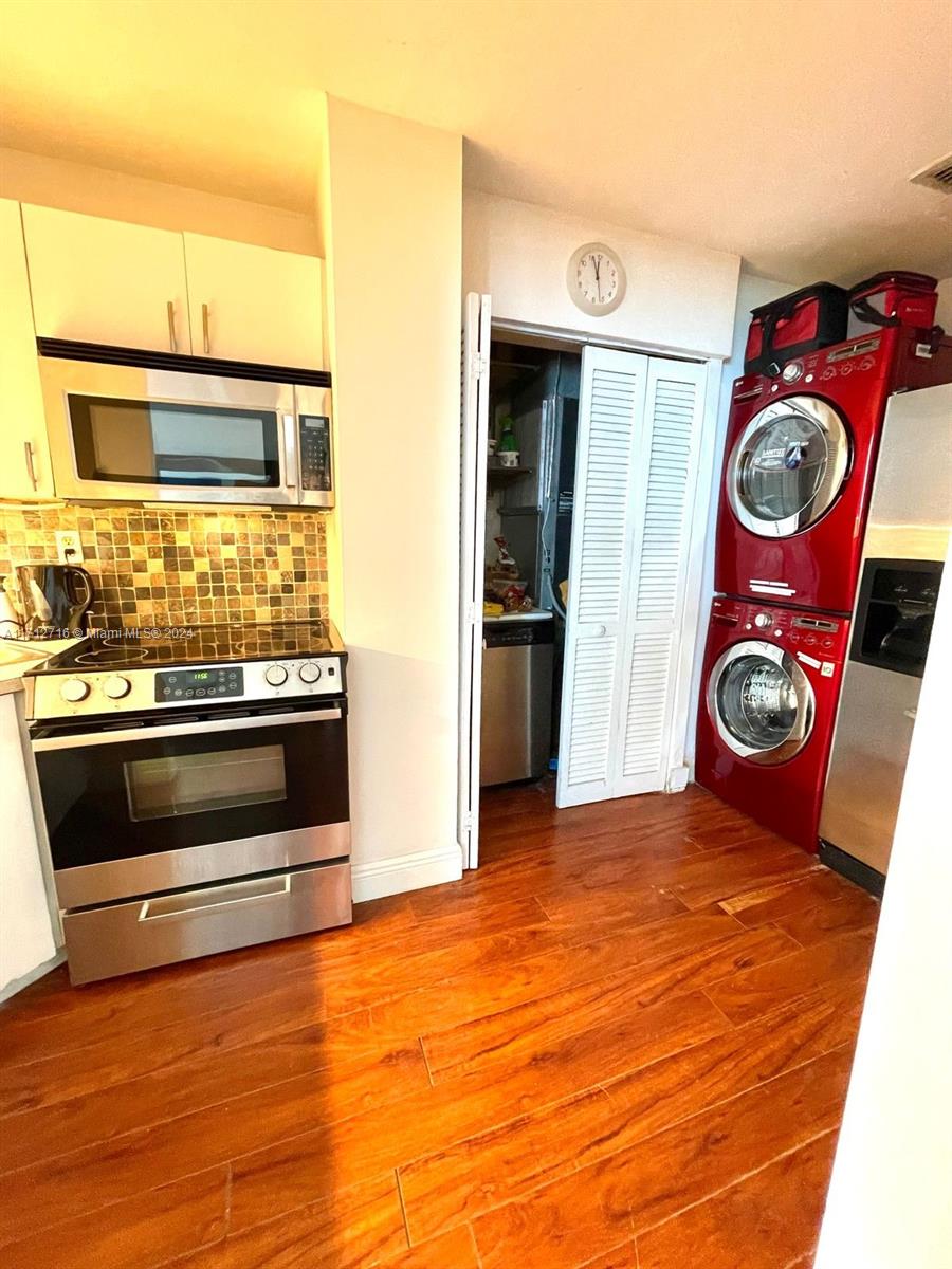 5445 Collins Avenue, Unit TS7 Miami Beach, FL 33140 - Photo 12 of 24 a view of kitchen and utility room with wooden floor