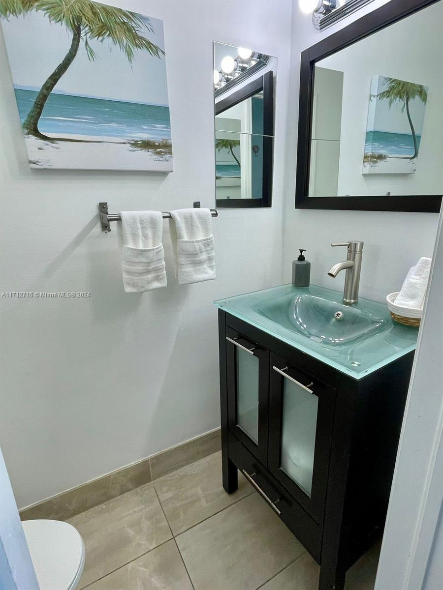 5445 Collins Avenue, Unit TS7 Miami Beach, FL 33140 - Photo 15 of 24 a bathroom with a sink and a mirror