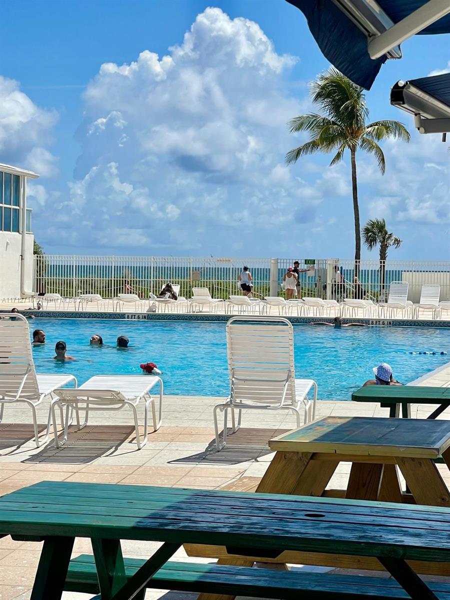 5445 Collins Avenue, Unit TS7 Miami Beach, FL 33140 - Photo 20 of 24 a view of a swimming pool with lounge chairs