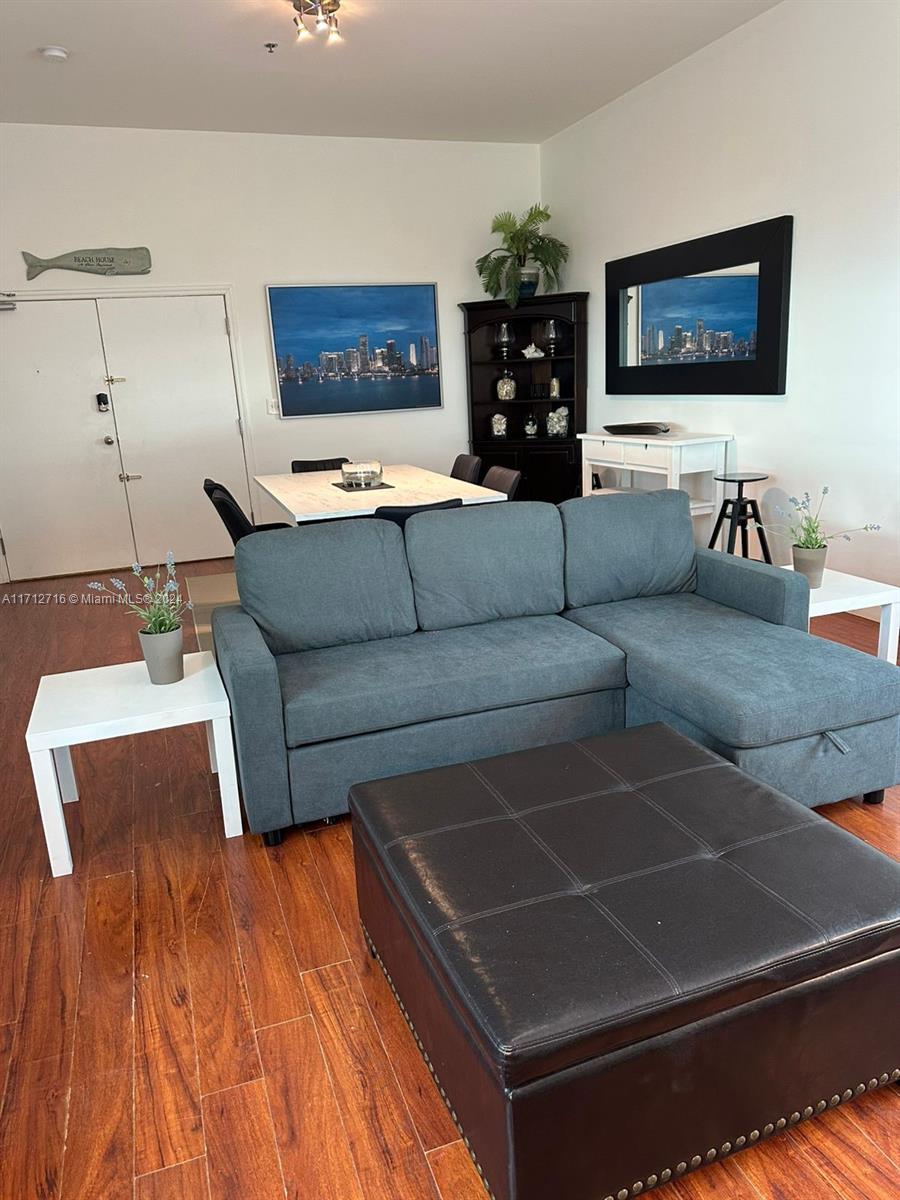 5445 Collins Avenue, Unit TS7 Miami Beach, FL 33140 - Photo 4 of 24 a living room with furniture and a flat screen tv