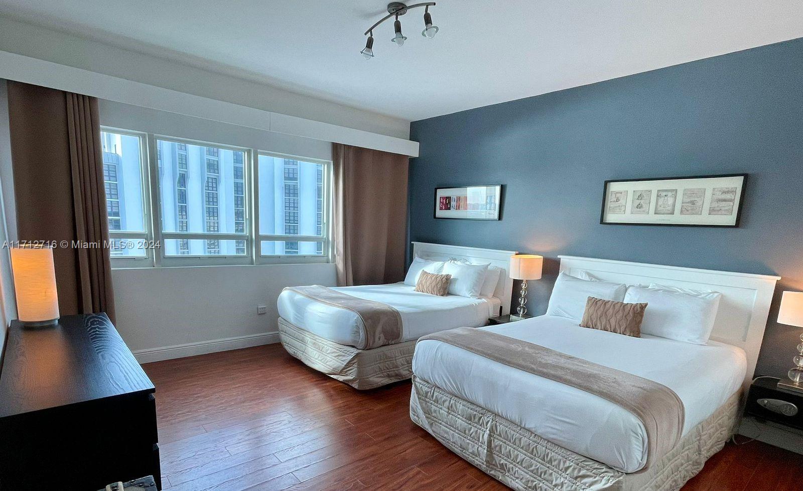 5445 Collins Avenue, Unit TS7 Miami Beach, FL 33140 - Photo 8 of 24 a bedroom with two beds and a window