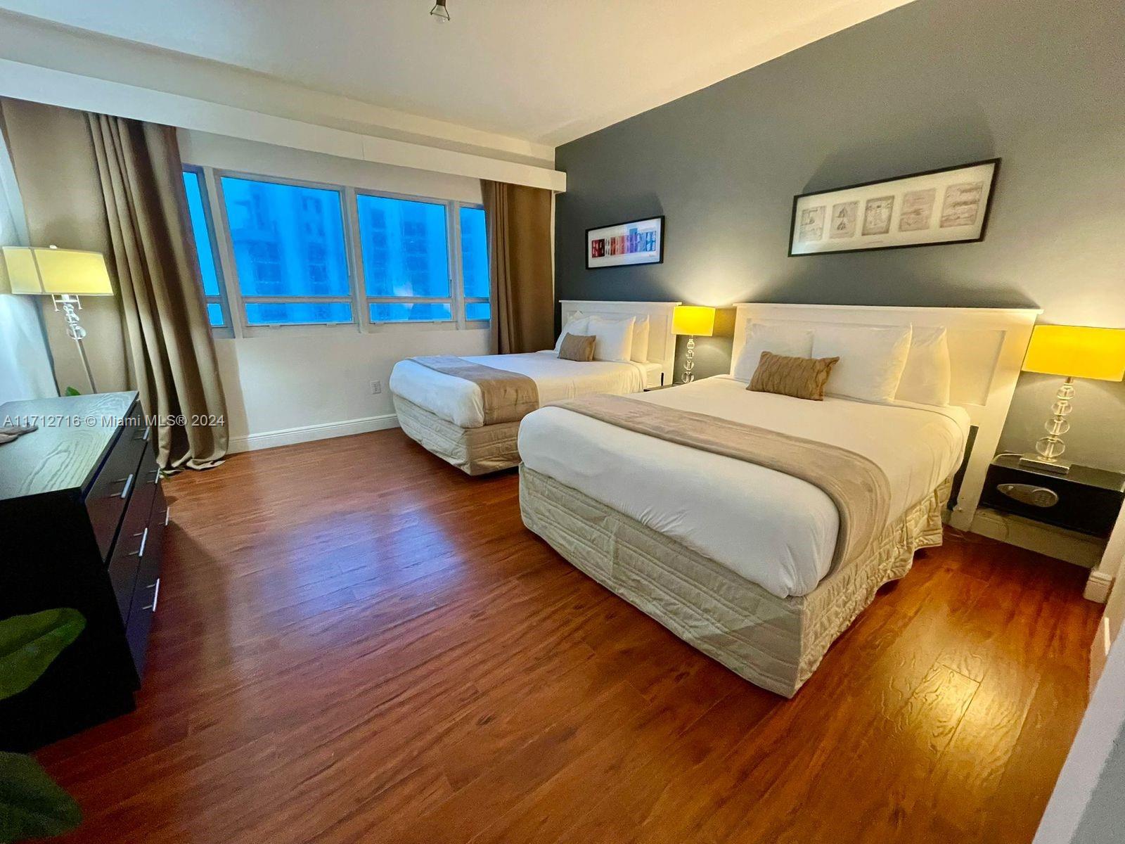 5445 Collins Avenue, Unit TS7 Miami Beach, FL 33140 - Photo 9 of 24 a bedroom with a bed and wooden floor