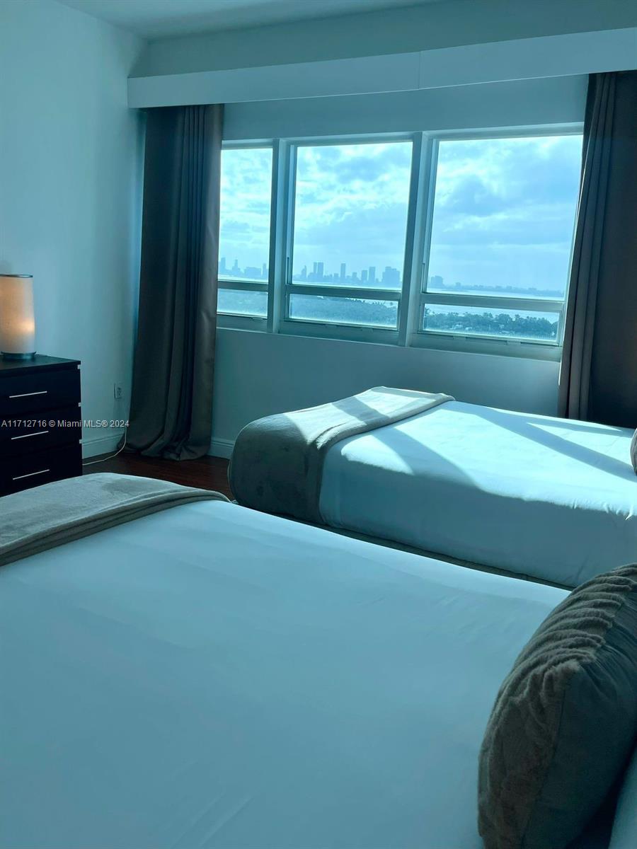 5445 Collins Avenue, Unit TS7 Miami Beach, FL 33140 - Photo 10 of 24 a bedroom with a bed and a window