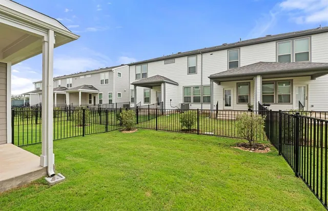a view of an house with backyard and porch