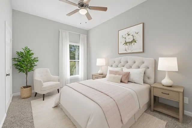 a bedroom with a bed and a potted plant