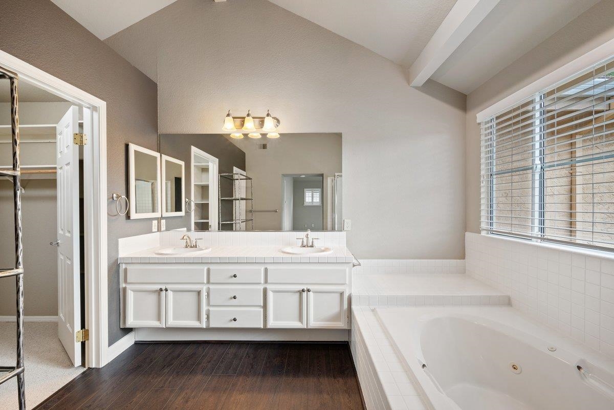 6206 Lakeview Circle San Ramon, CA 94582 - Photo 37 of 57 a bathroom with a tub a double vanity sink and a large mirror