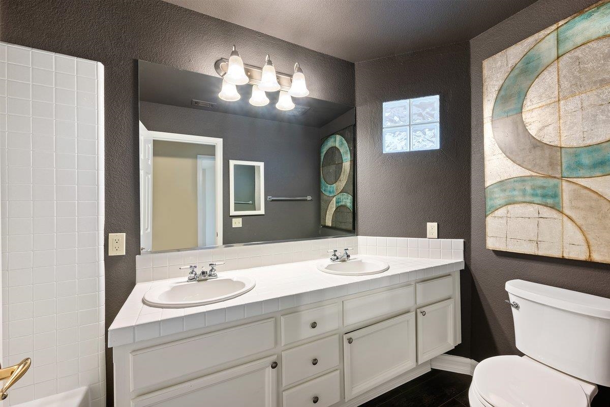 6206 Lakeview Circle San Ramon, CA 94582 - Photo 42 of 57 a bathroom with a toilet sink and mirror